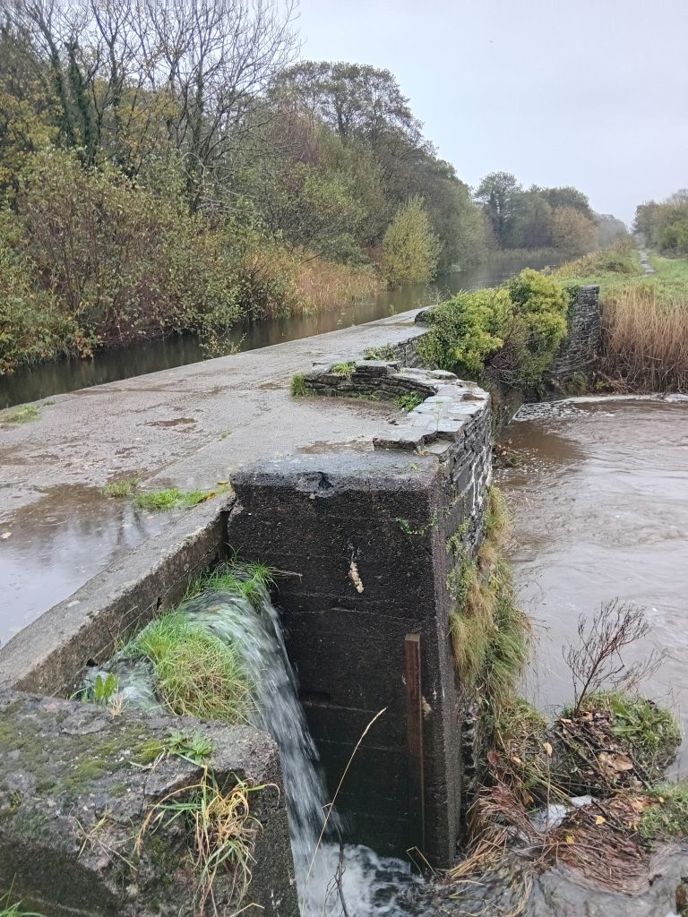 Canal aqueduct, rubble stone, two arches with cutwater between. 
