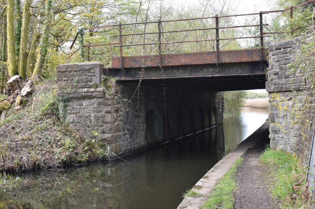 The western bridge carries the Crymlyn Burrows/Swansea Docks railway line.