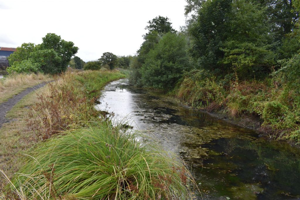 The canal bends away from Neath and begins its gentle curve toward Neath Abbey.