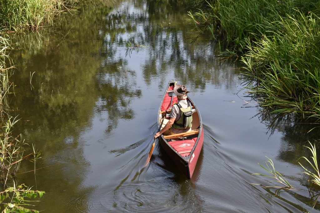 Old wooden canoe glides down the shallow Tennant Canal 2026