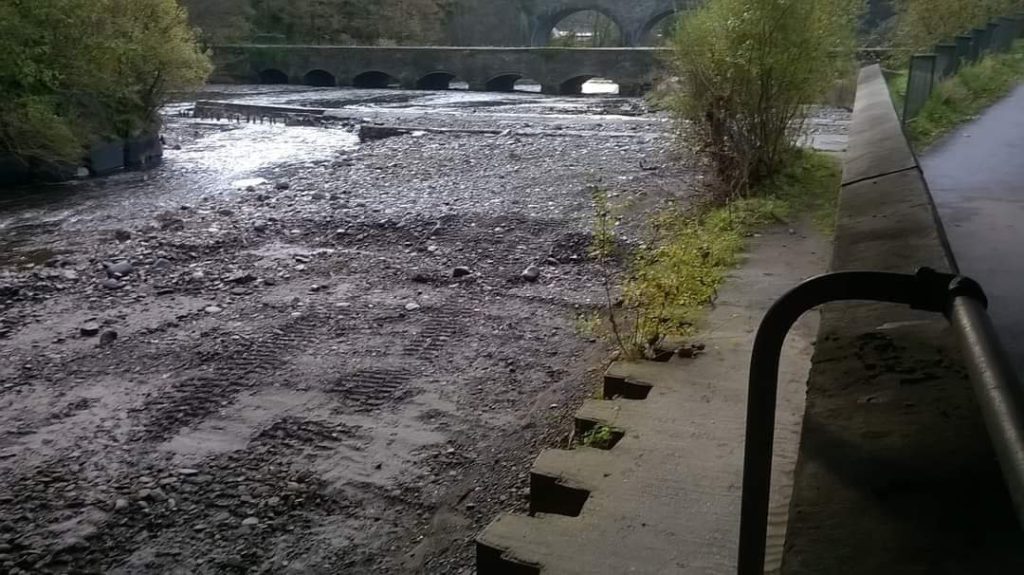 Wide track lines left in 2015 by heavy contract machinery on Dulais River at Aberdulais